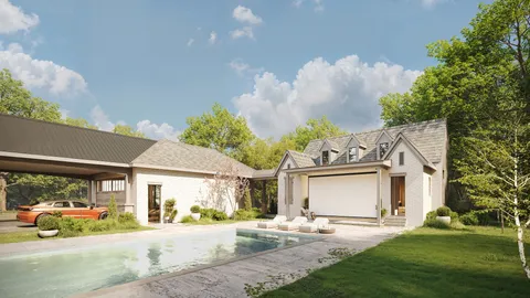 a view of a white house with a large windows and a yard with plants