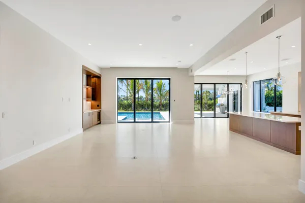 a living room with furniture and large windows