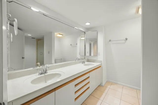 a bathroom with a sink double vanity and a mirror
