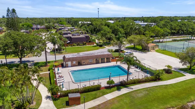 an aerial view of a house with a garden and lake view