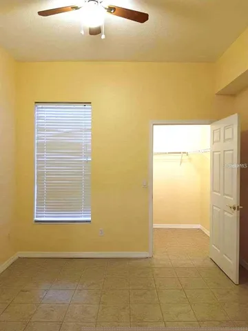 a view of a livingroom with an empty space and a window