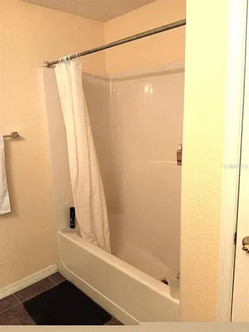 a bathroom with a bathtub and shower