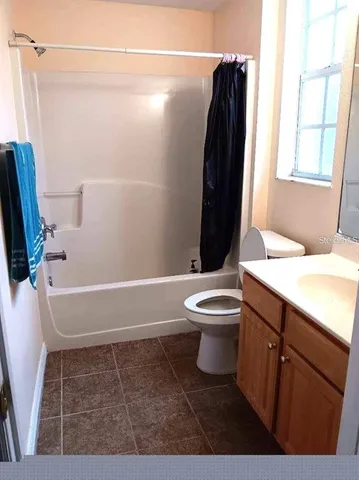 a bathroom with a toilet a sink and bathtub
