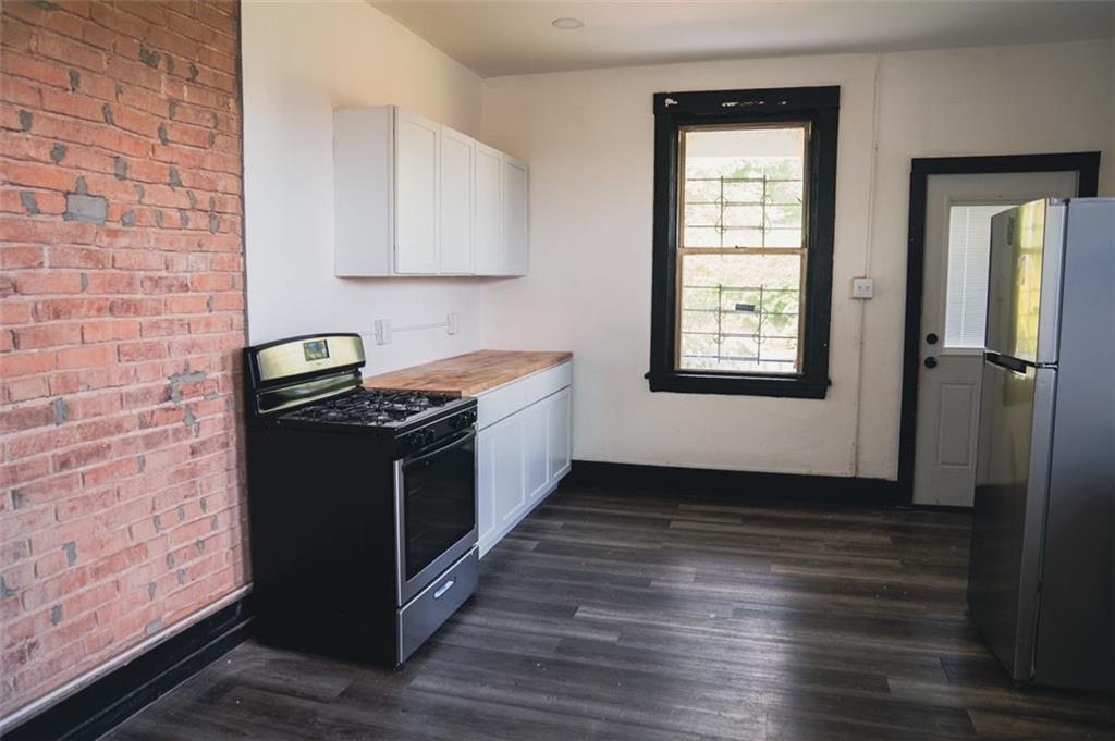 620 Kirkpatrick Street Pittsburgh, PA 15219 - Photo 7 of 15 a kitchen with stainless steel appliances granite countertop a stove a sink and a refrigerator