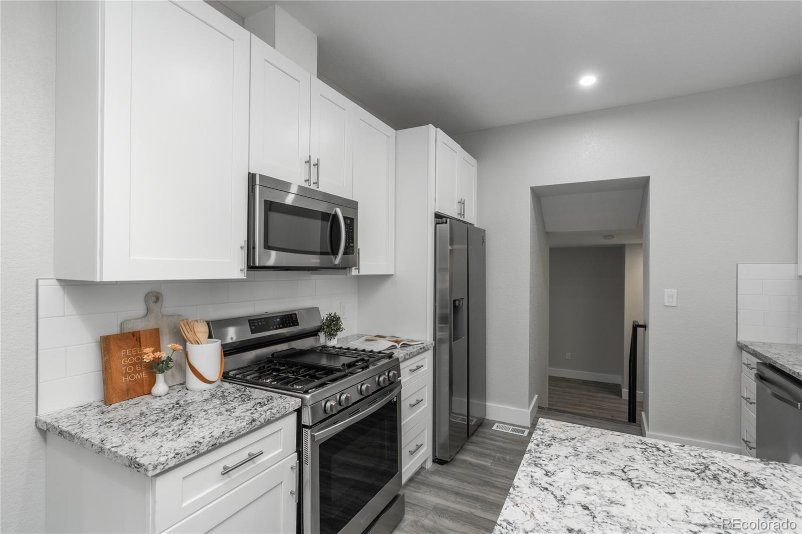 2339 South Acoma Street Denver, CO 80223 - Photo 15 of 36 a kitchen with stainless steel appliances granite countertop a stove a sink and a refrigerator