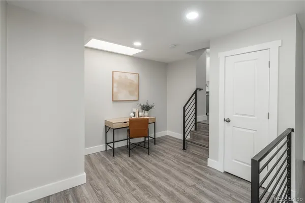 a view of a room with wooden floor and furniture