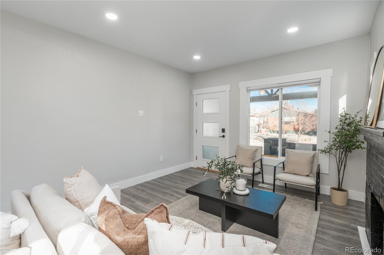 2339 South Acoma Street Denver, CO 80223 - Photo 5 of 36 a living room with furniture and wooden floor
