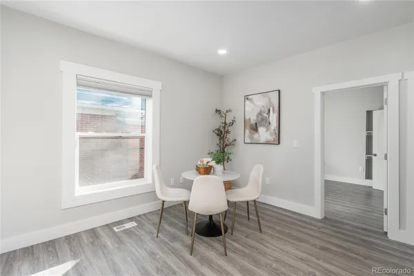 a view of a dining room with furniture window and wooden floor