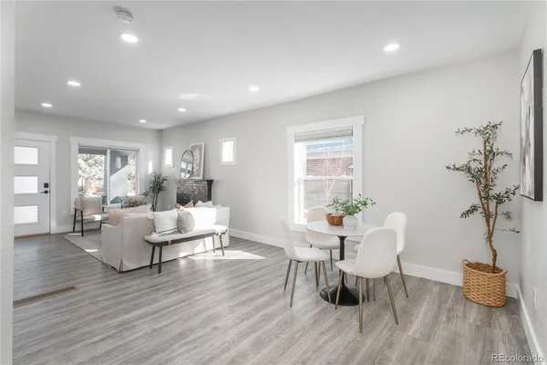 a living room with dining room and wooden floor