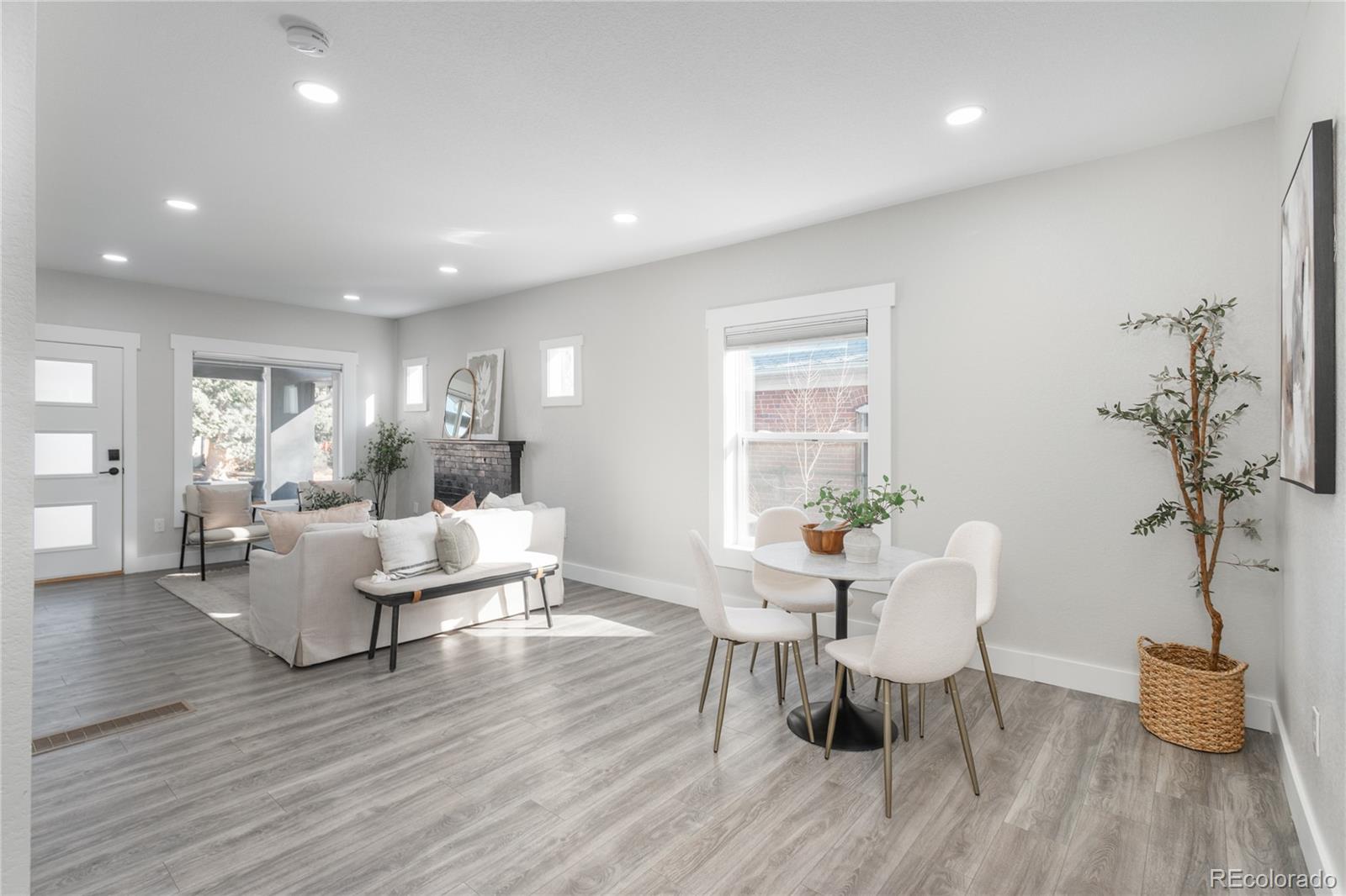 2339 South Acoma Street Denver, CO 80223 - Photo 8 of 36 a living room with dining room and wooden floor