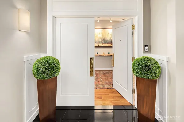 a view of a hallway with wooden floor and entryway