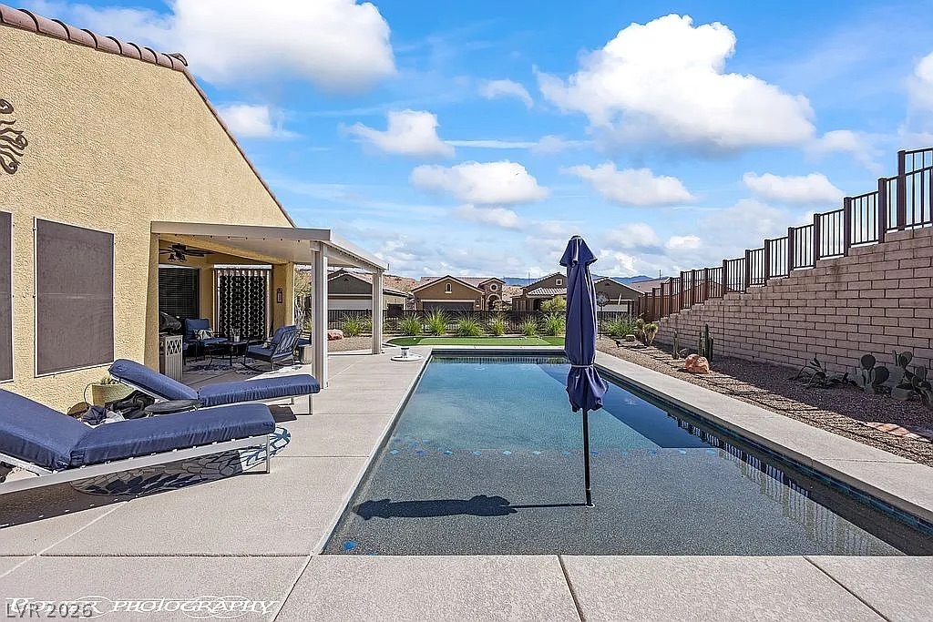 1304 Cottage Ridge Mesquite, NV 89034 - Photo 35 of 52 An inviting backyard oasis offers a sparkling pool and a covered patio for year-round enjoyment.