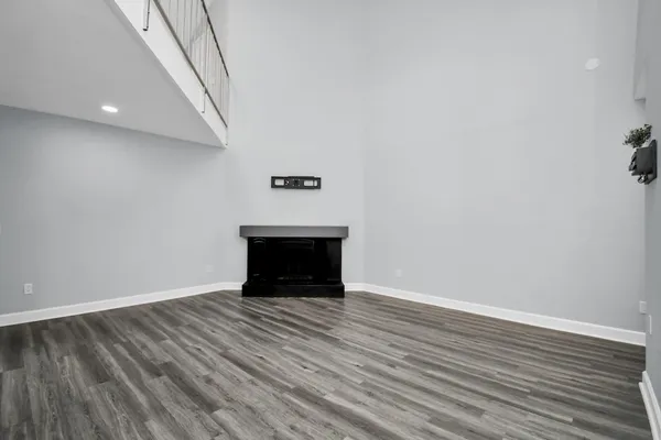 a view of an empty room with wooden floor