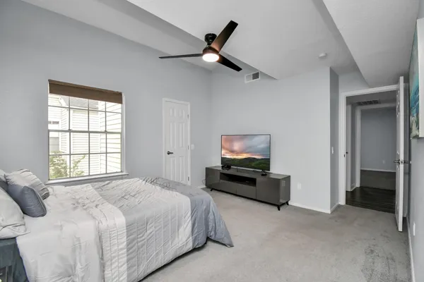 a bedroom with a bed and a television