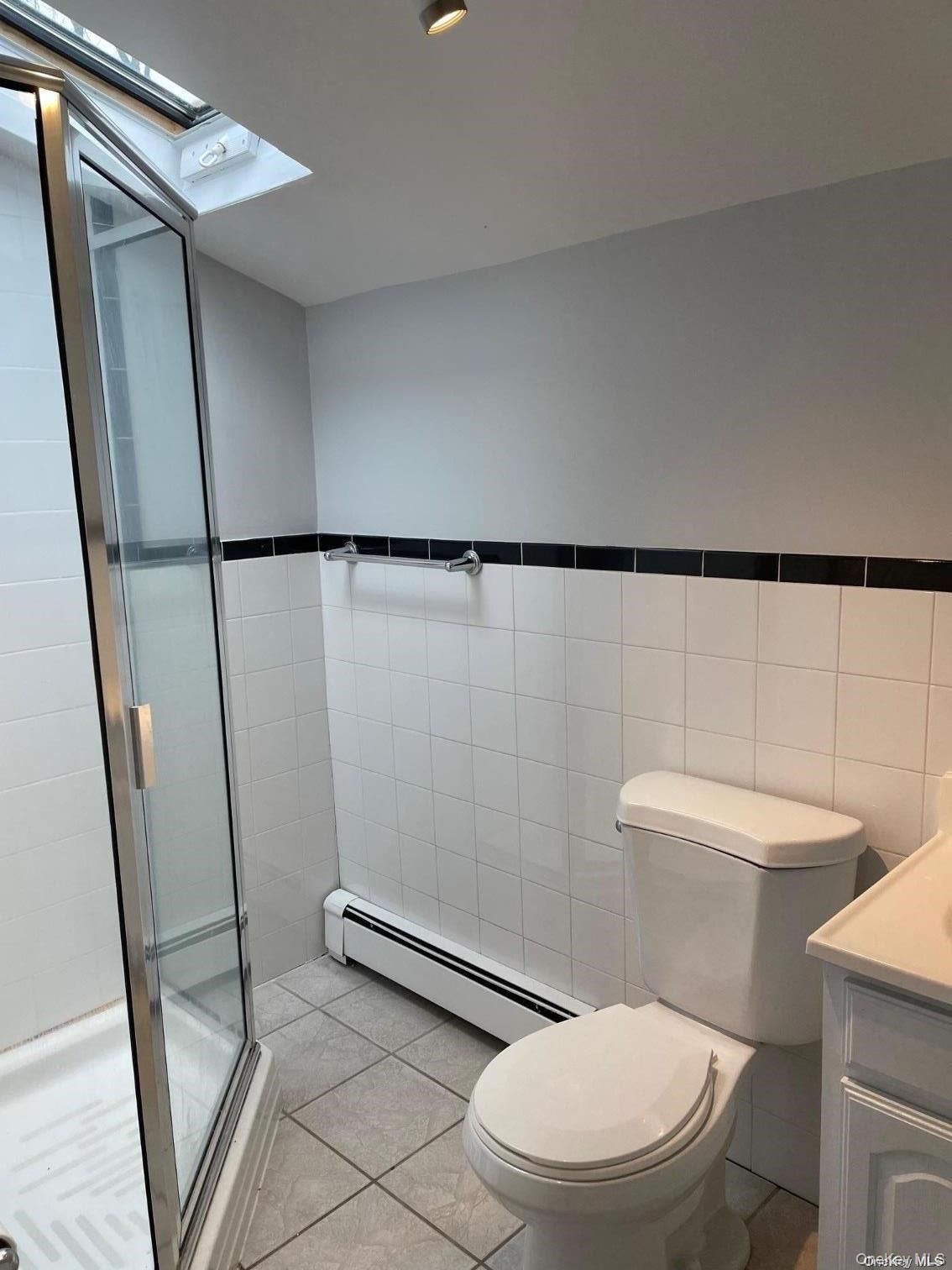 51 Centershore Road, Unit UPPR Centerport, NY 11721 - Photo 13 of 20 a white toilet sitting next to a shower