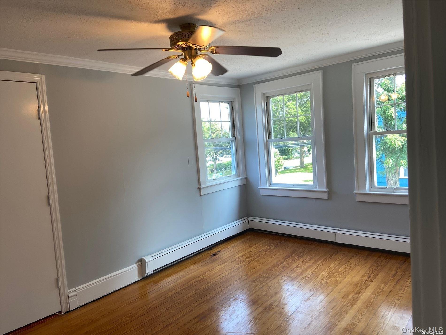 51 Centershore Road, Unit UPPR Centerport, NY 11721 - Photo 15 of 20 a view of room with window and ceiling fan