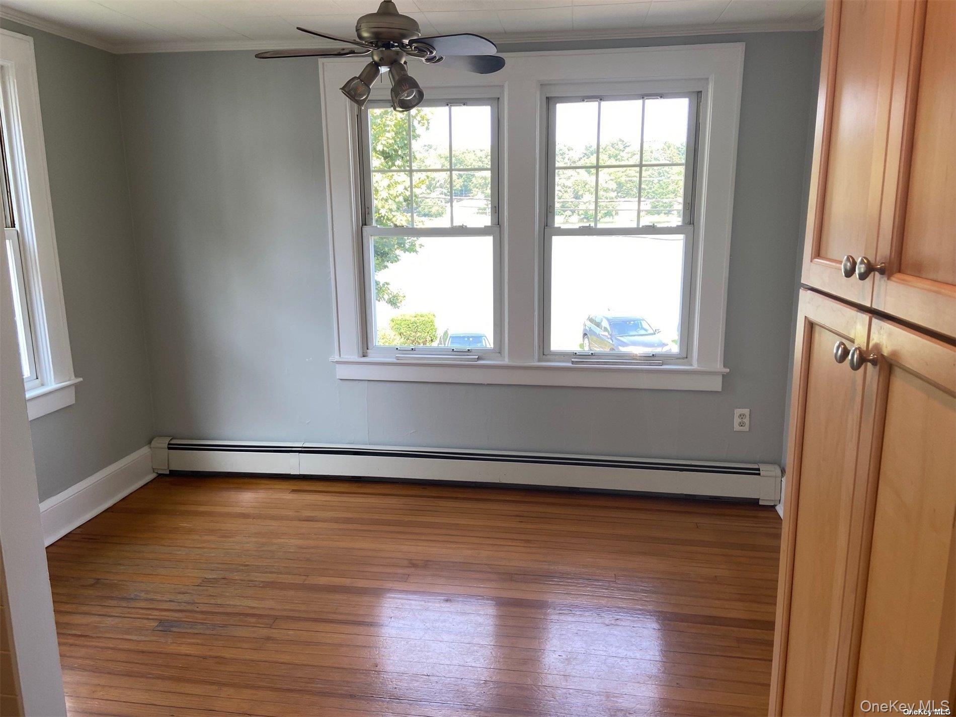 51 Centershore Road, Unit UPPR Centerport, NY 11721 - Photo 7 of 20 an empty room with wooden floor and windows