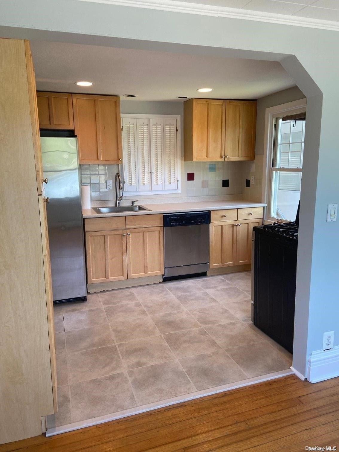 51 Centershore Road, Unit UPPR Centerport, NY 11721 - Photo 8 of 20 a kitchen with granite countertop a stove a sink dishwasher and a refrigerator