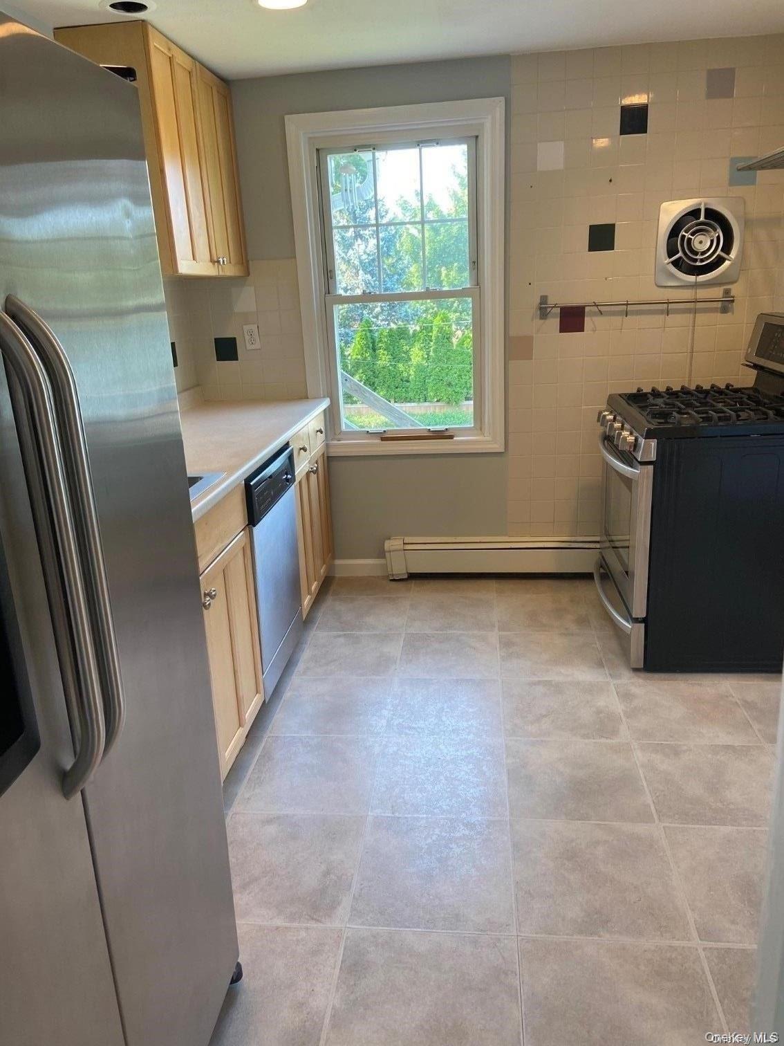 51 Centershore Road, Unit UPPR Centerport, NY 11721 - Photo 9 of 20 a kitchen with stainless steel appliances a refrigerator and a stove