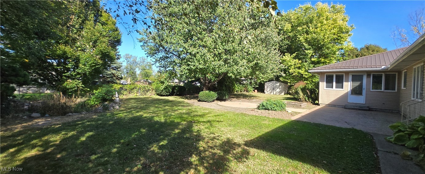 2707 Merriweather Road Sandusky, OH 44870 - Photo 5 of 28 View of yard with a storage unit and a patio area