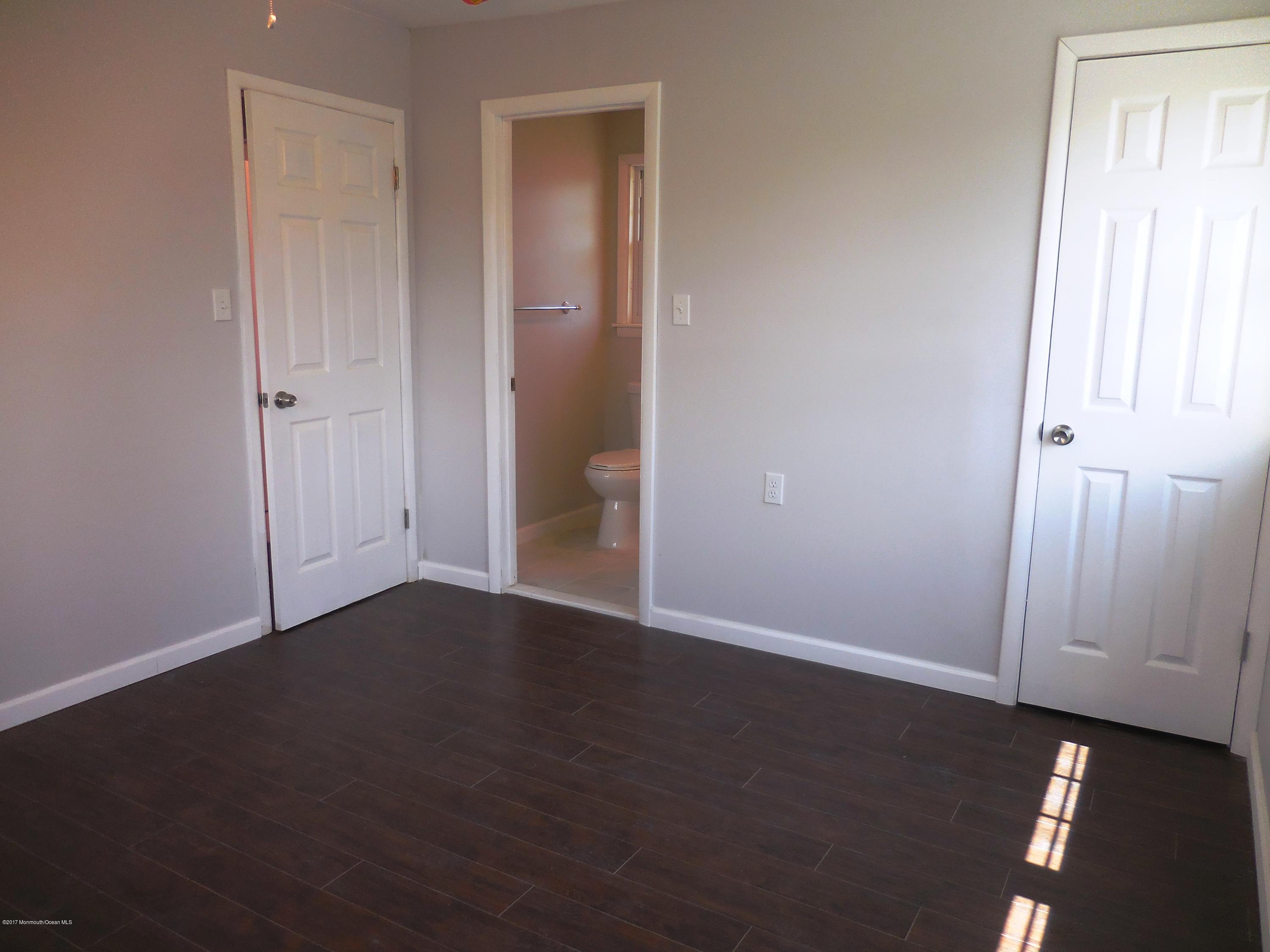 10 Brooke Road Brick, NJ 08724 - Photo 17 of 38 an empty room with wooden floor and windows