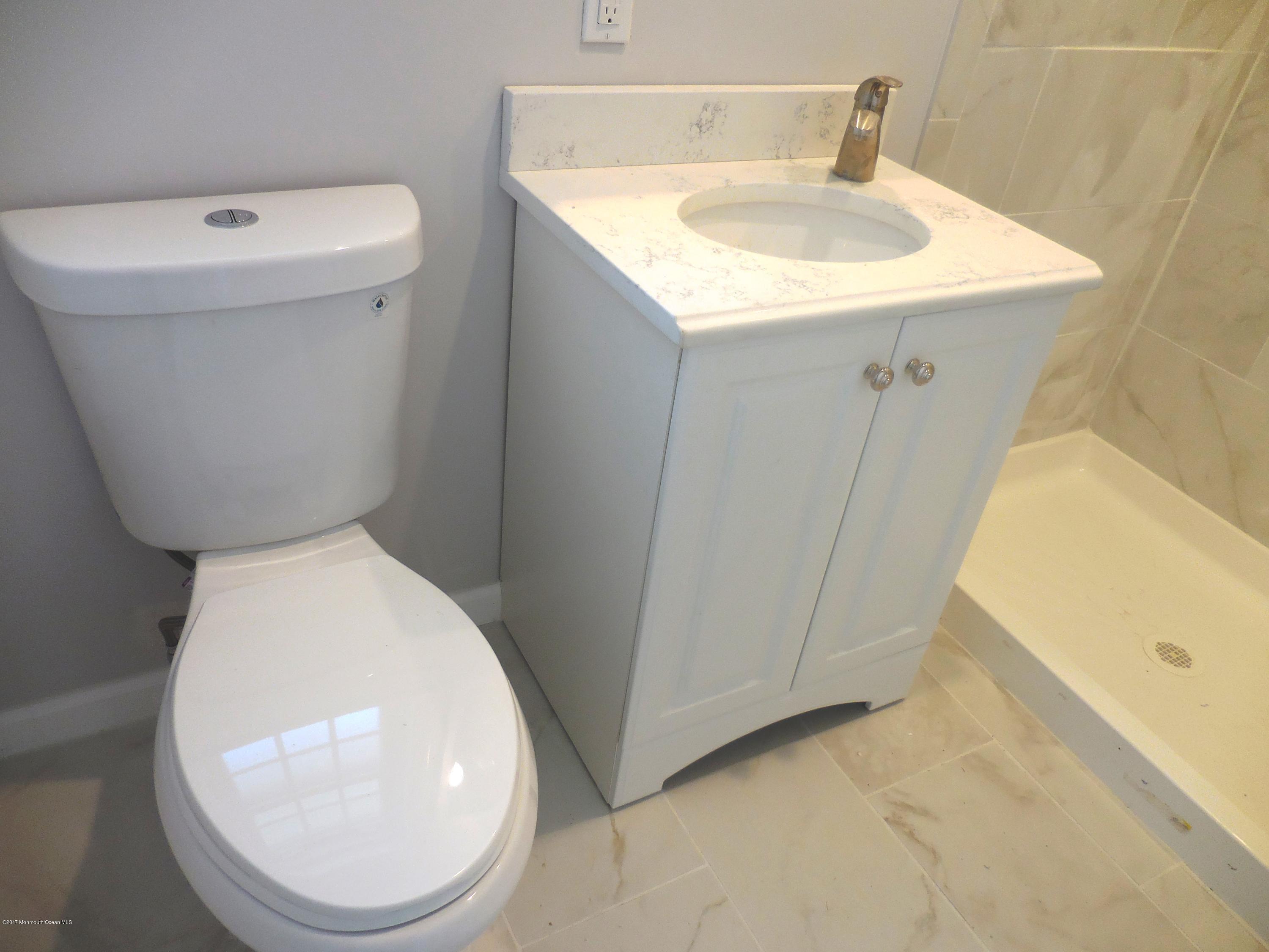 10 Brooke Road Brick, NJ 08724 - Photo 19 of 38 a bathroom with a sink a toilet and a mirror