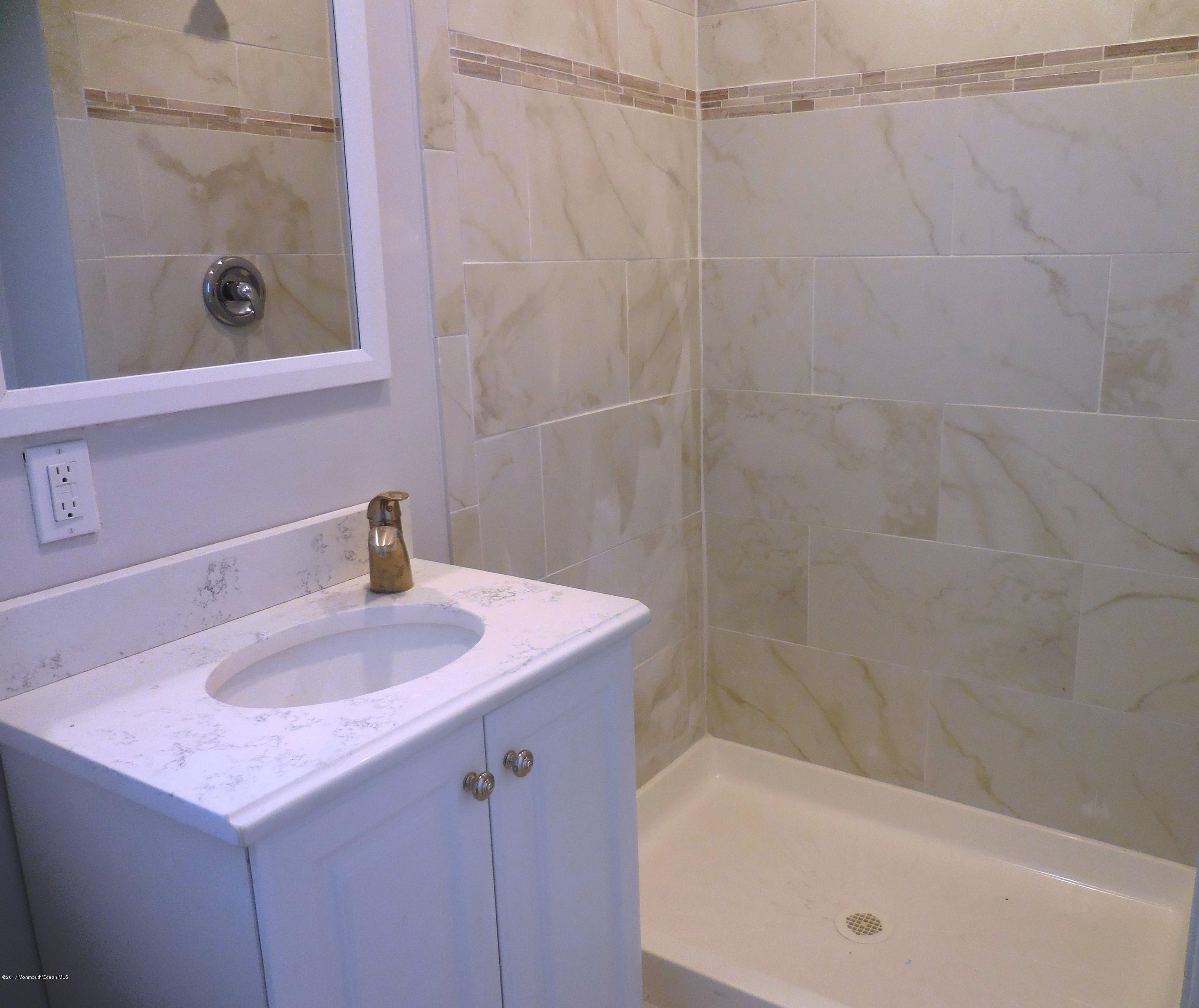 10 Brooke Road Brick, NJ 08724 - Photo 22 of 38 a bathroom with a sink and a bathtub with shower