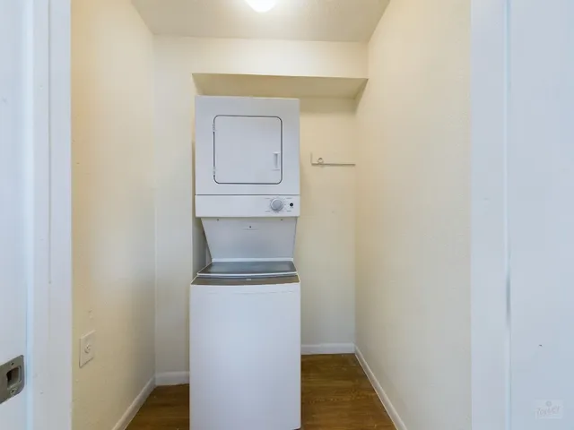 a utility room with a sink and mirror