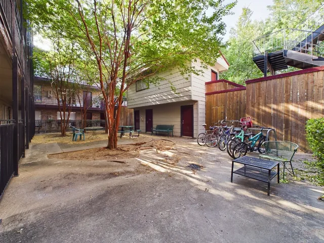 a view of a chairs and tables in the back yard of the house
