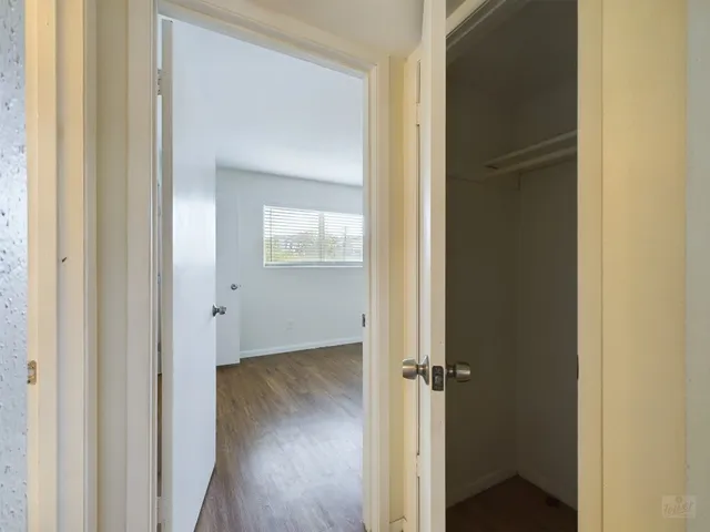 a view of a hallway with wooden floor