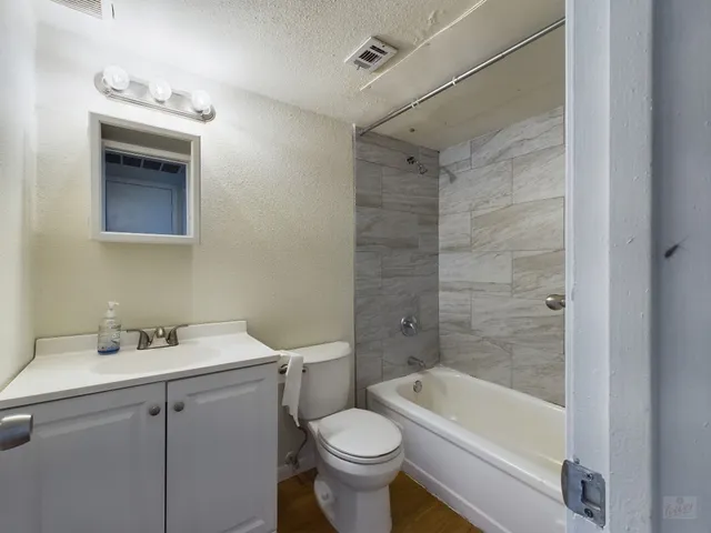 a bathroom with a sink toilet and bathtub