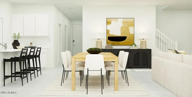 a kitchen with a table chairs microwave and cabinets