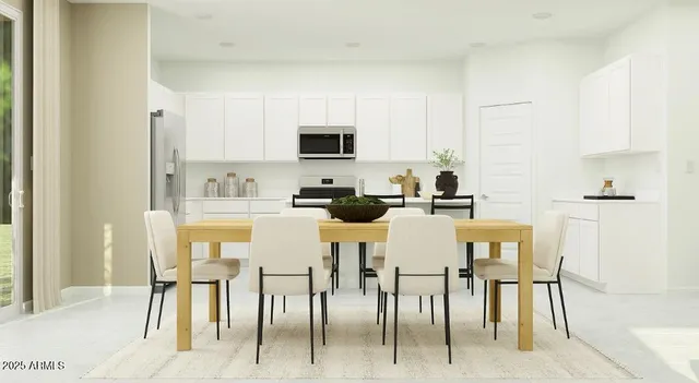 a kitchen with a table chairs refrigerator and cabinets