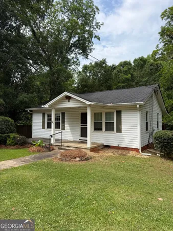a front view of house with yard and green space