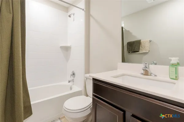 a bathroom with a granite countertop sink toilet a shower and a bathtub