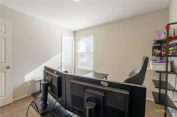 a view of a workspace with furniture