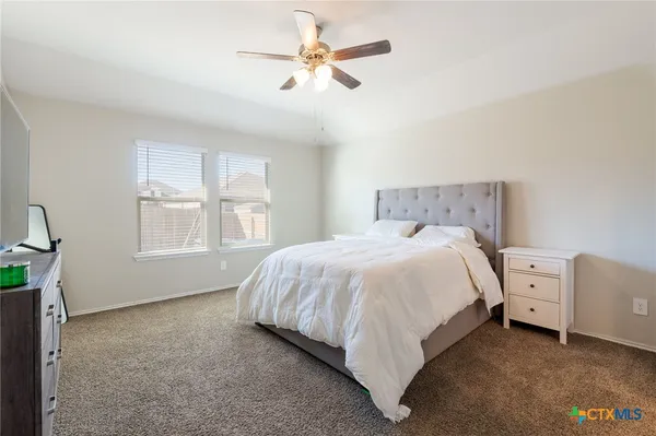 a bed room with bed and a window