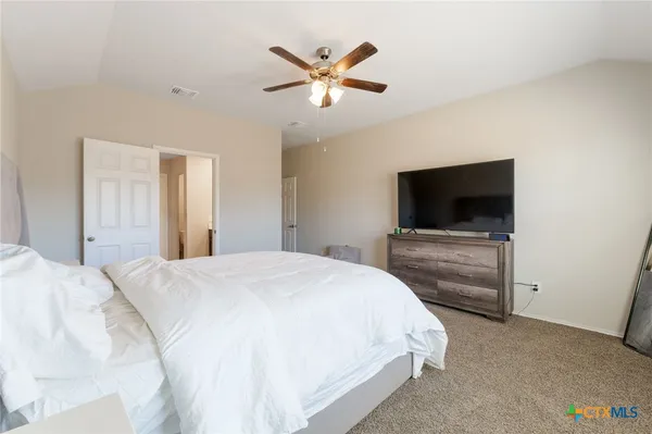a bedroom with a bed and a flat screen tv