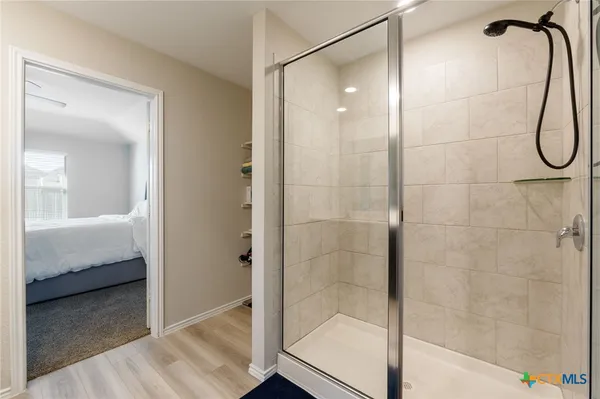 a bathroom with a shower and a sink
