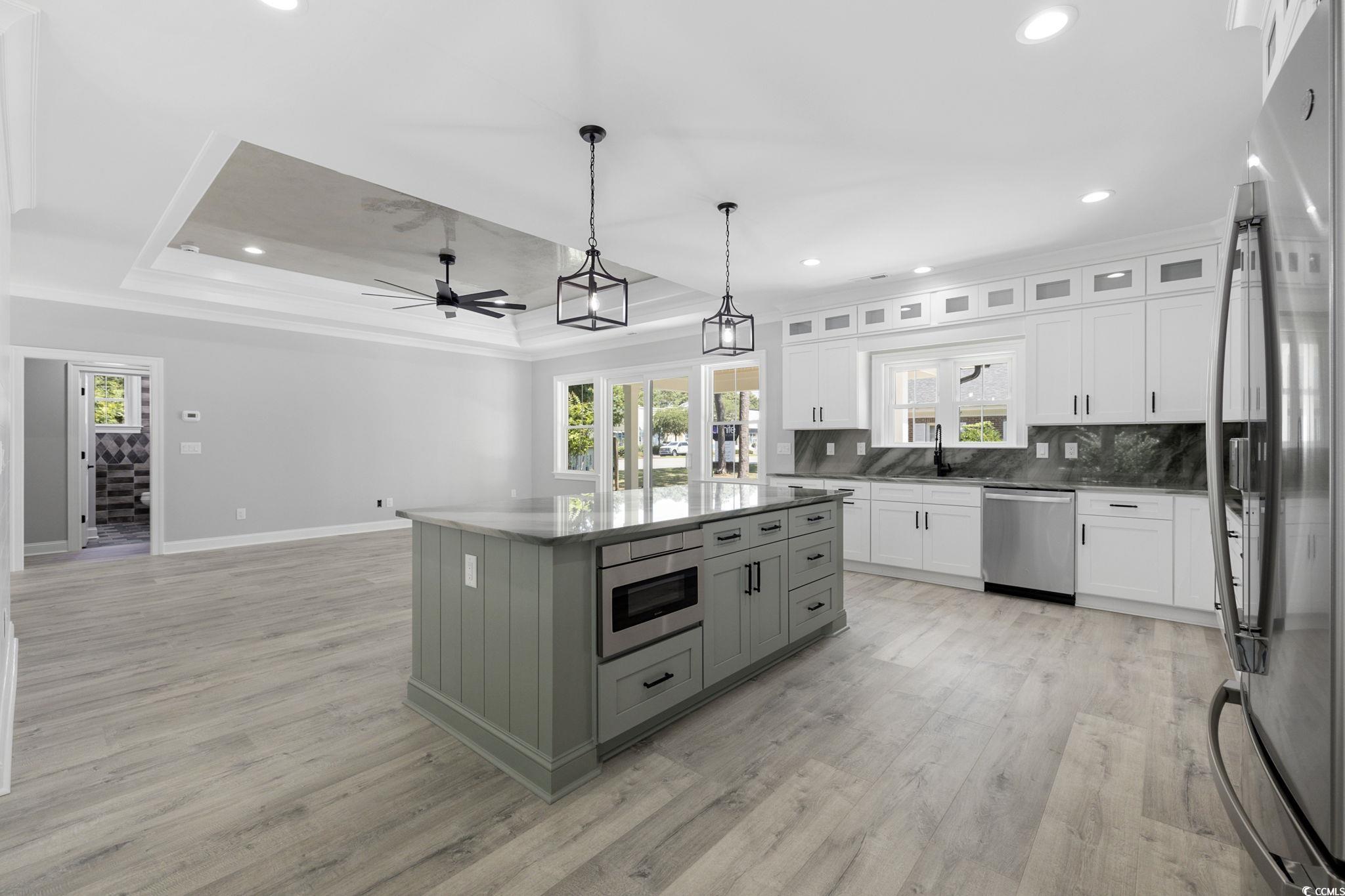 4806 North Kings Highway Myrtle Beach, SC 29577 - Photo 17 of 38 Kitchen featuring ornamental molding, stainless steel appliances, recessed lighting, light wood-style flooring, and white cabinets
