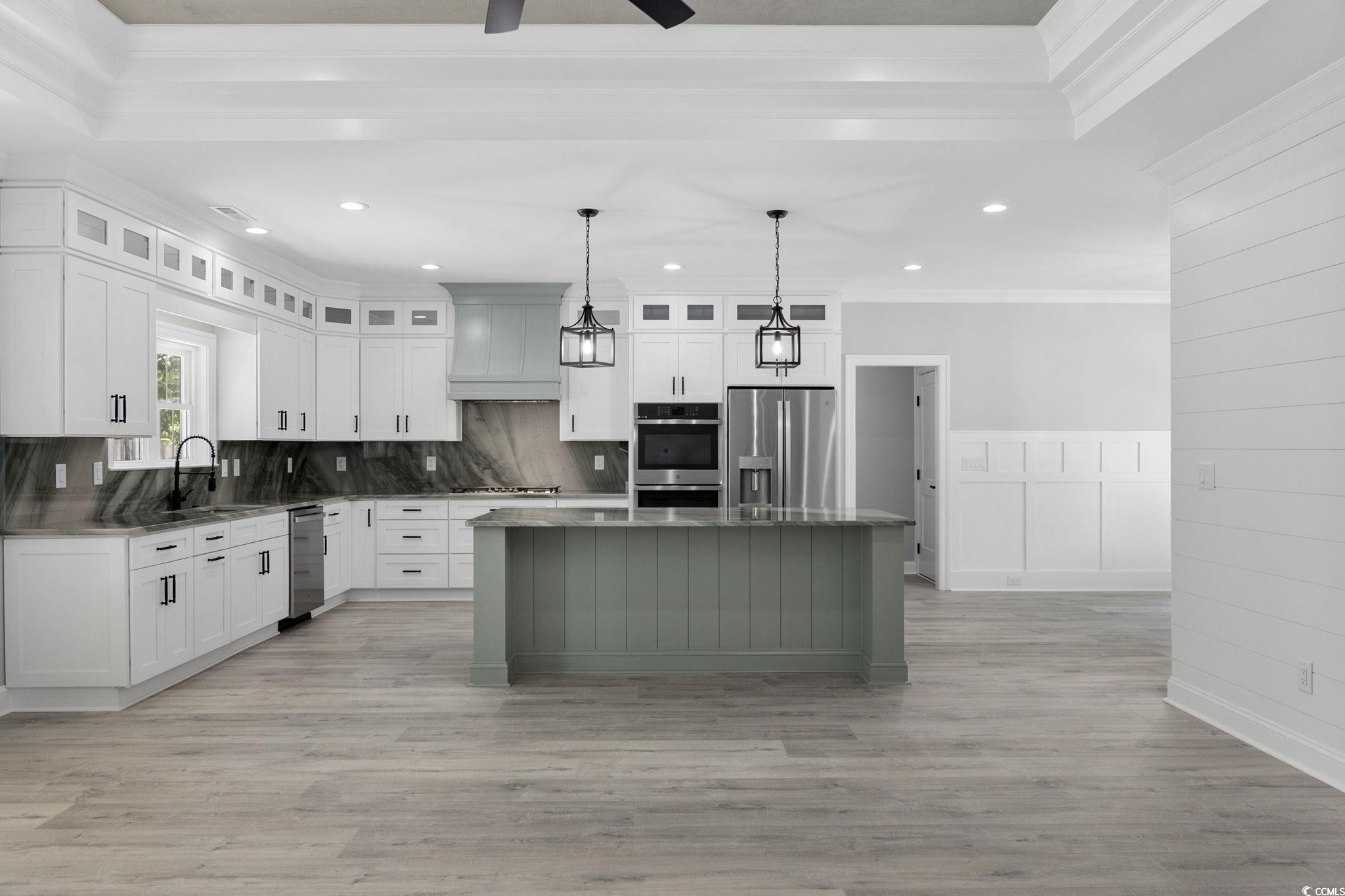 4806 North Kings Highway Myrtle Beach, SC 29577 - Photo 21 of 38 Kitchen featuring crown molding, recessed lighting, ceiling fan, appliances with stainless steel finishes, and a kitchen island