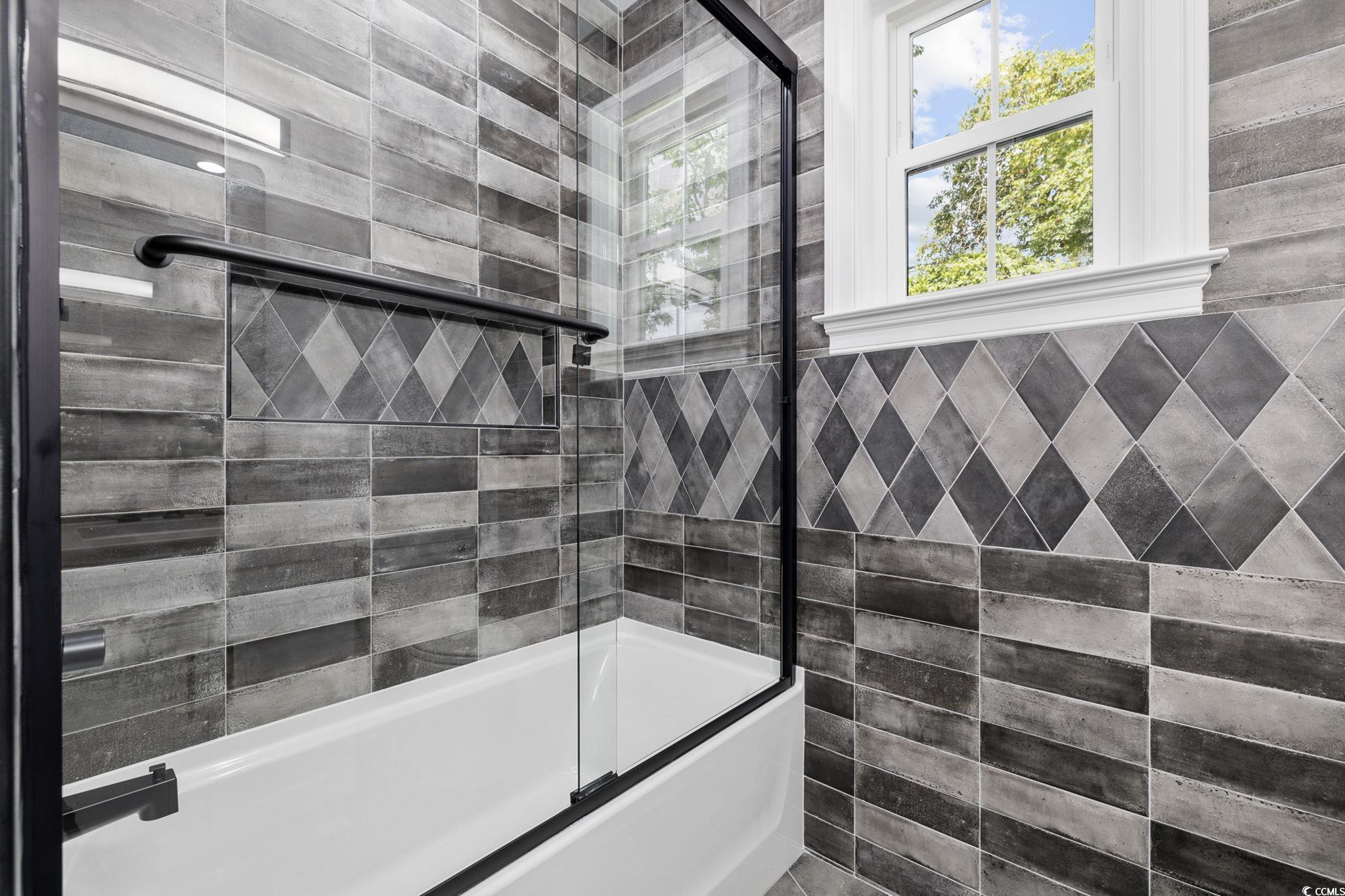 4806 North Kings Highway Myrtle Beach, SC 29577 - Photo 26 of 38 Full bath with enclosed tub / shower combo and tile walls