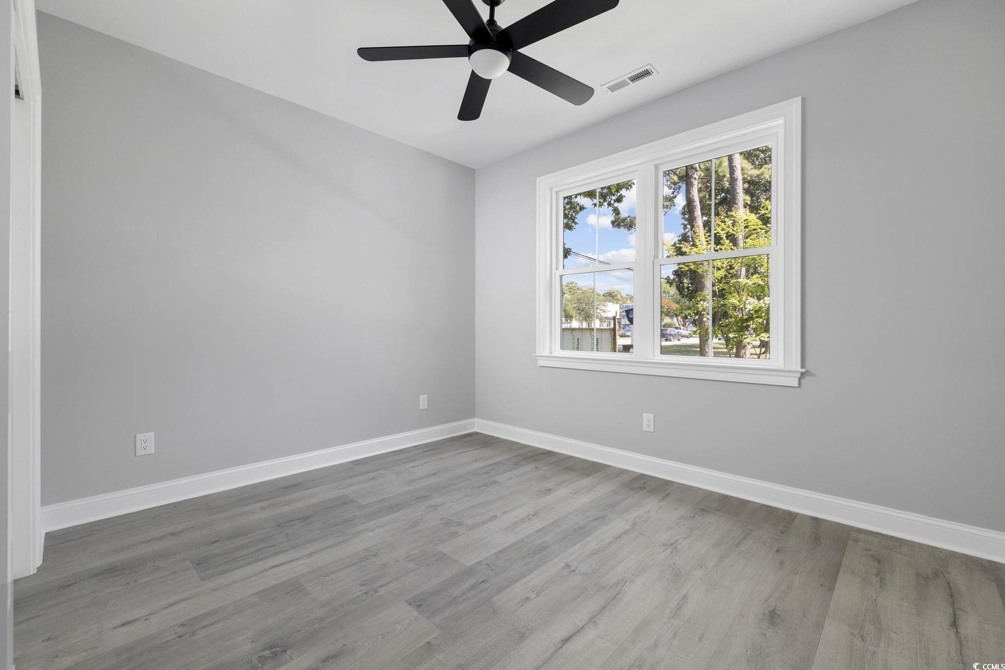 4806 North Kings Highway Myrtle Beach, SC 29577 - Photo 27 of 38 Unfurnished room with wood finished floors and a ceiling fan