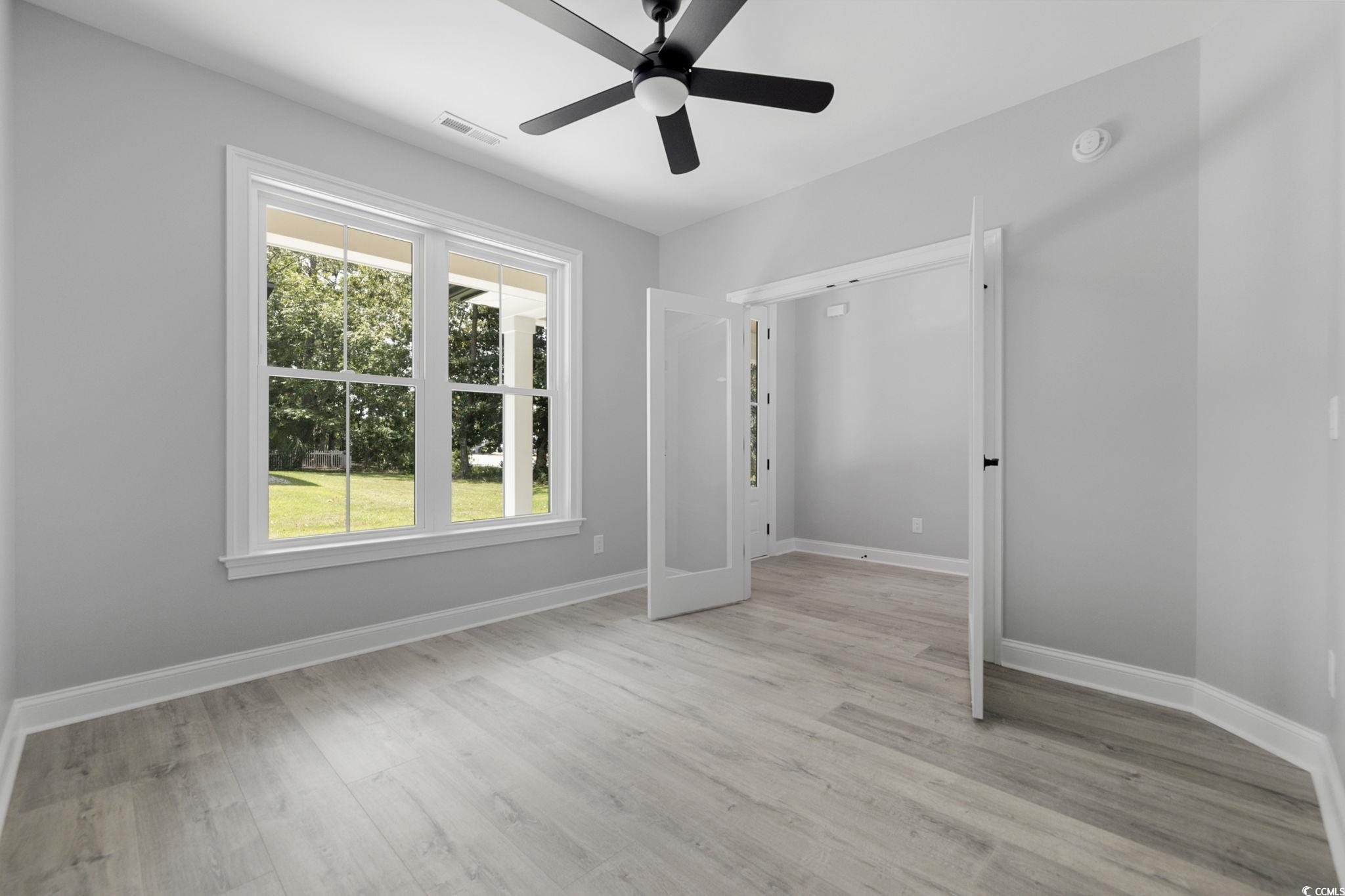 4806 North Kings Highway Myrtle Beach, SC 29577 - Photo 29 of 38 Unfurnished bedroom featuring light wood finished floors and a ceiling fan
