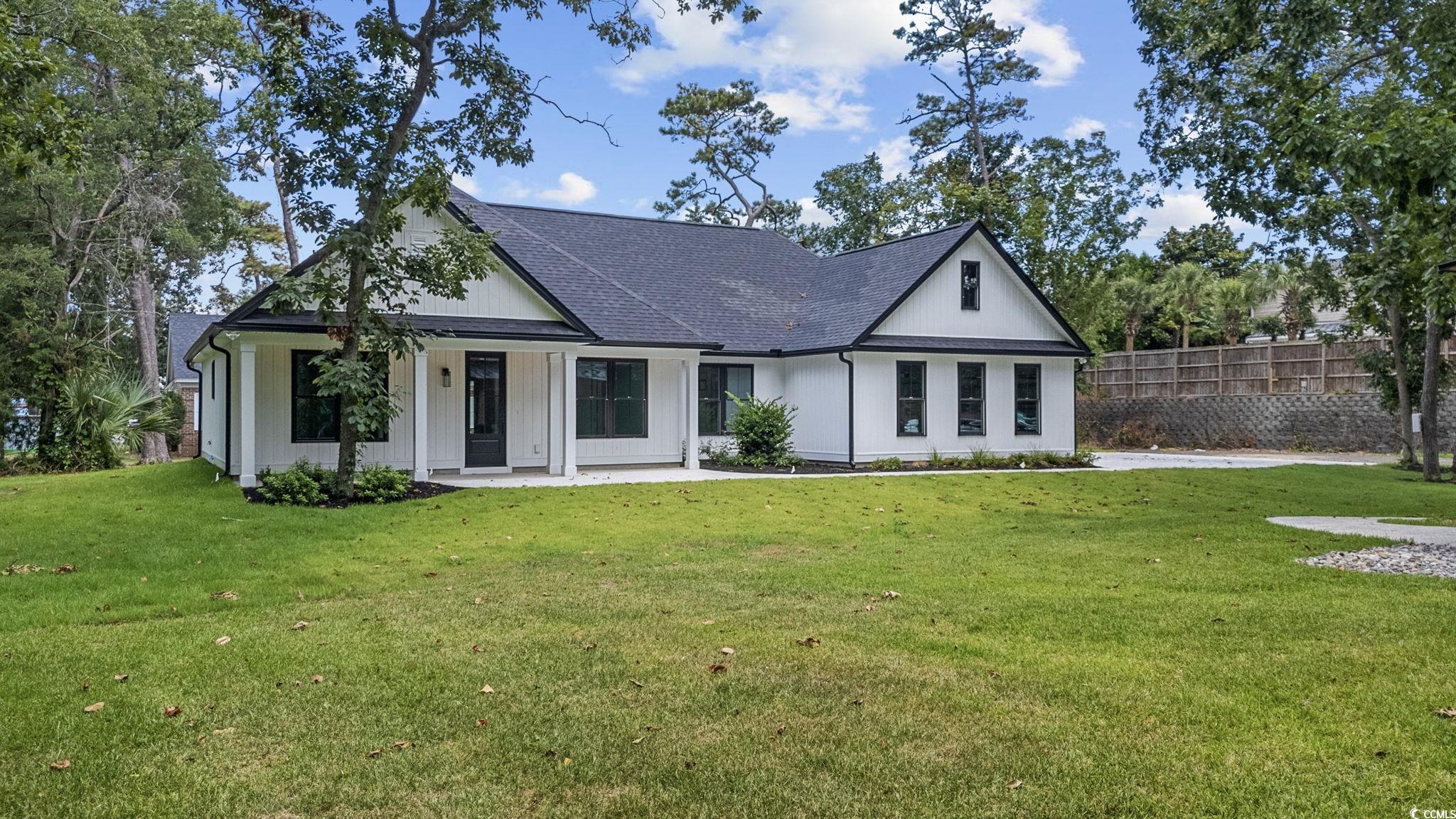 4806 North Kings Highway Myrtle Beach, SC 29577 - Photo 4 of 38 View of front facade with a shingled roof
