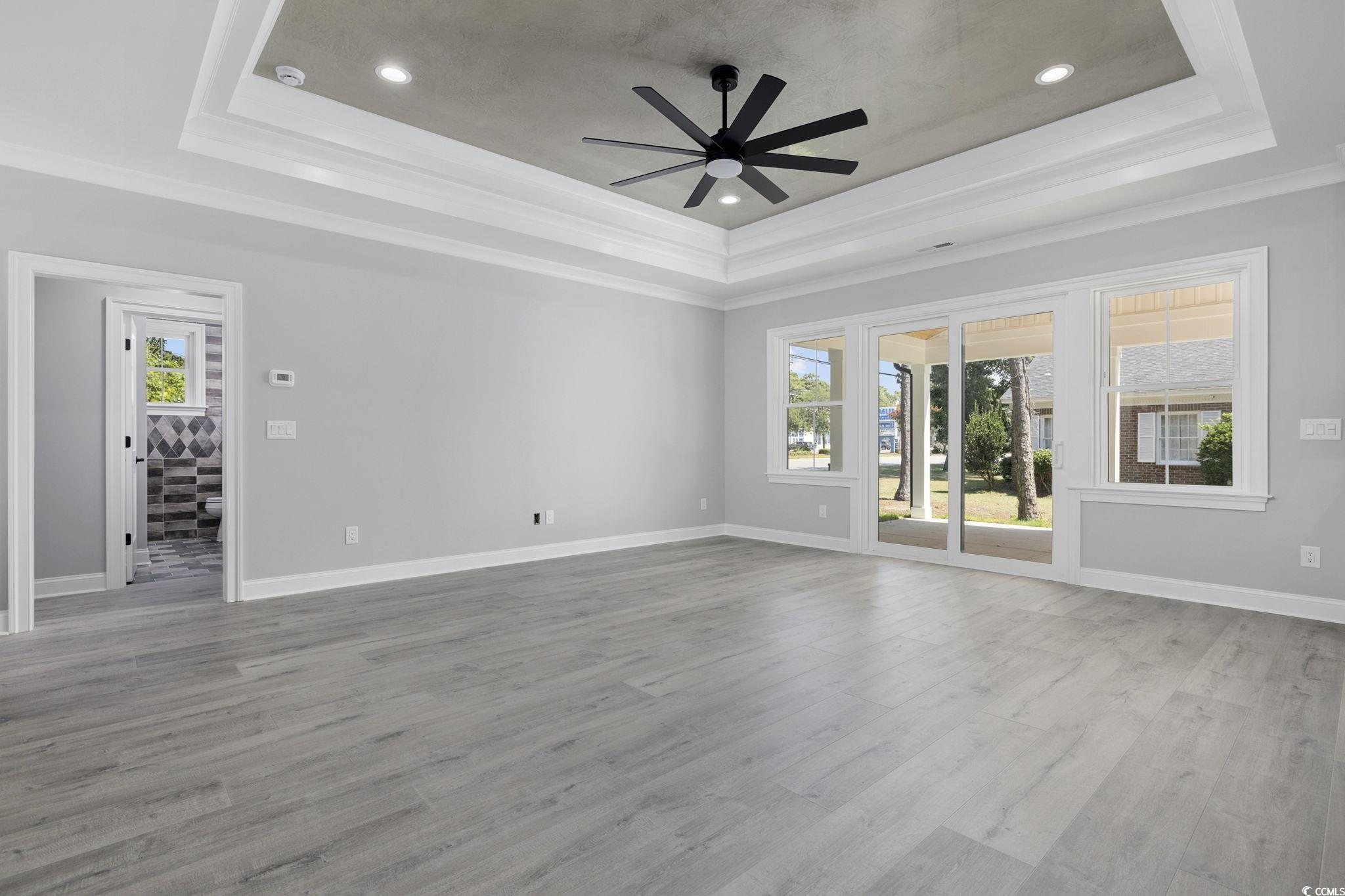4806 North Kings Highway Myrtle Beach, SC 29577 - Photo 8 of 38 Unfurnished room with ceiling fan, ornamental molding, wood finished floors, a tray ceiling, and recessed lighting