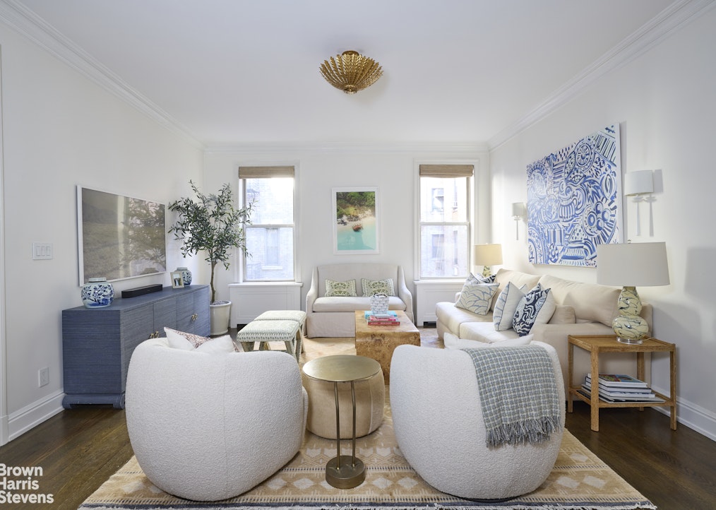 19 East 95th Street, Unit 4R Manhattan, NY 10128 - Photo 2 of 7 a living room with furniture and window