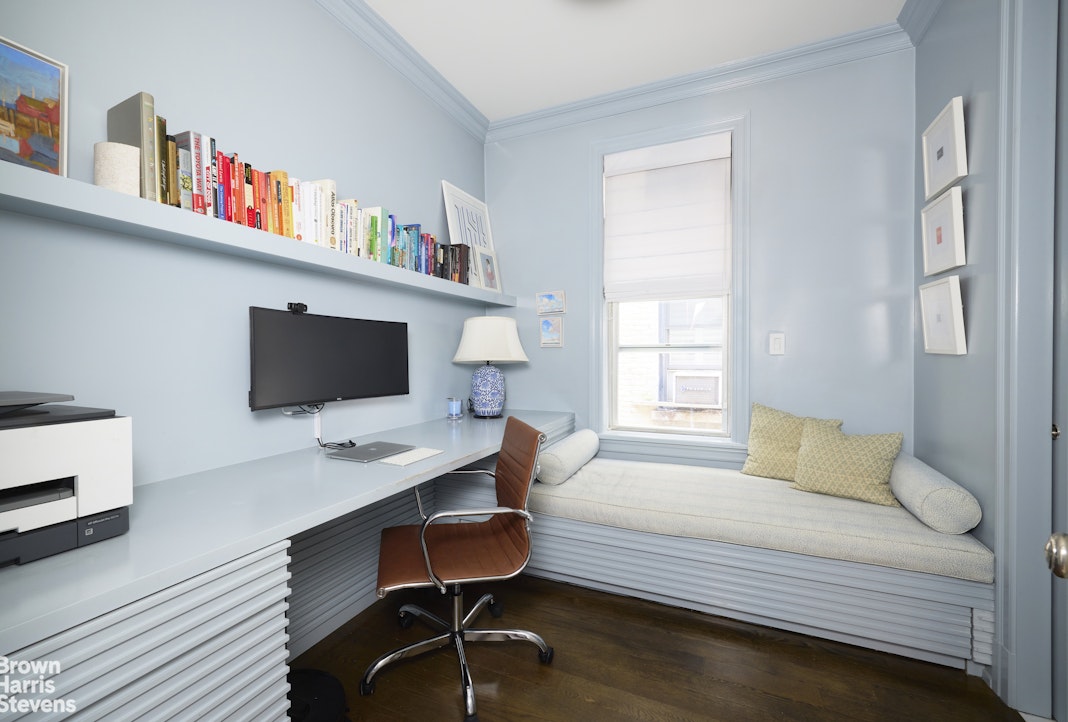 19 East 95th Street, Unit 4R Manhattan, NY 10128 - Photo 5 of 7 a bedroom with a bed and a bookshelf