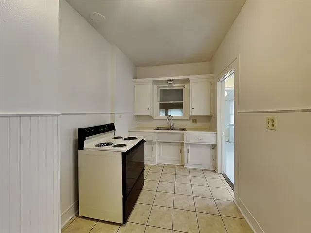 a kitchen with a stove sink and a refrigerator