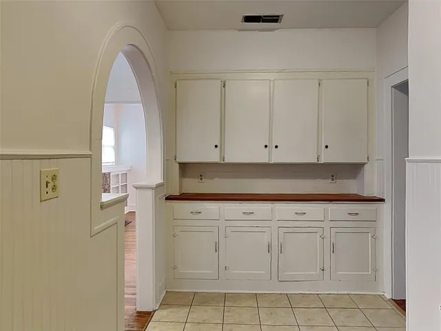 a view of a kitchen with white cabinets